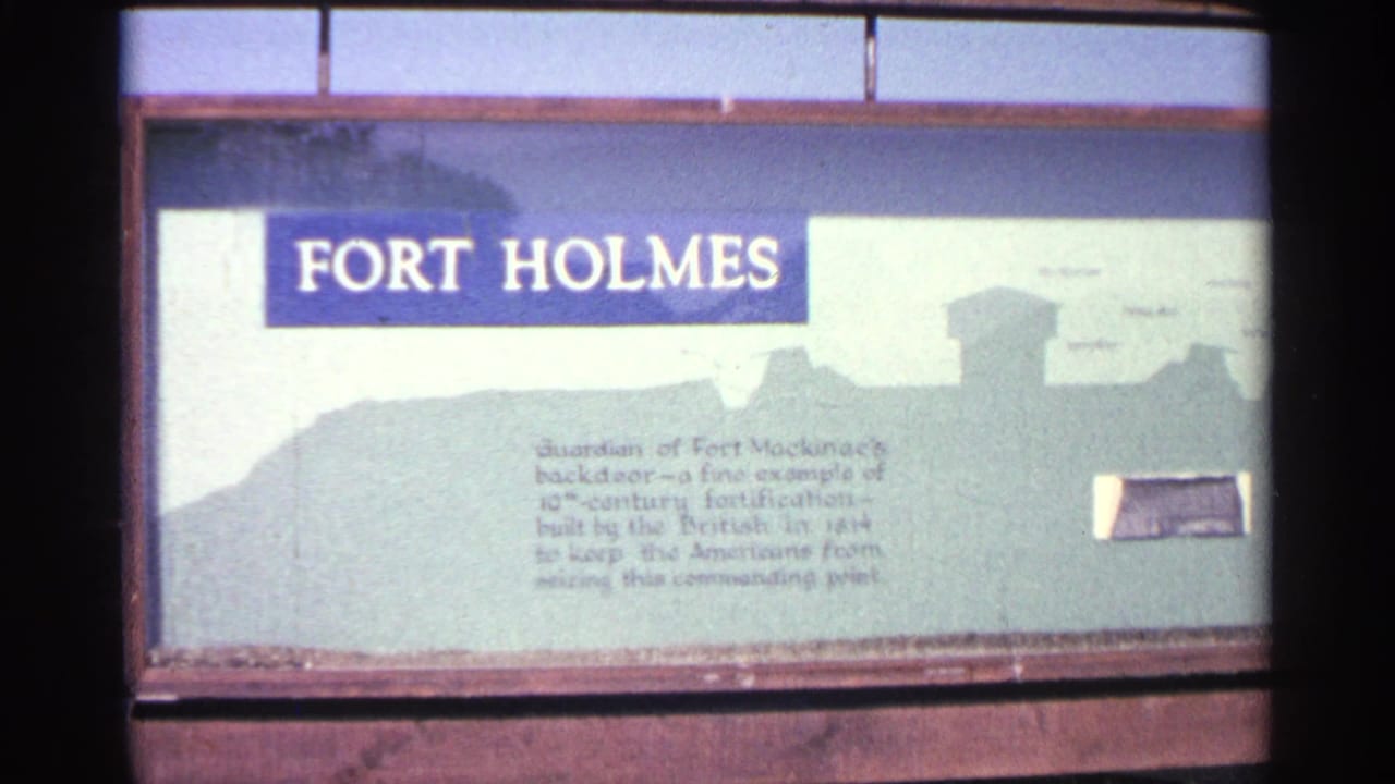 Close view of a Fort Holmes interpretive sign in Michigan, with large lettering, explanatory text, and a fort silhouette graphic.