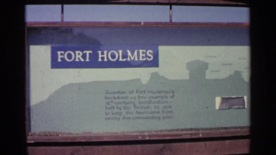 Final frame holds on the Fort Holmes interpretive sign, including the large title, printed text, and stylized fort silhouette.