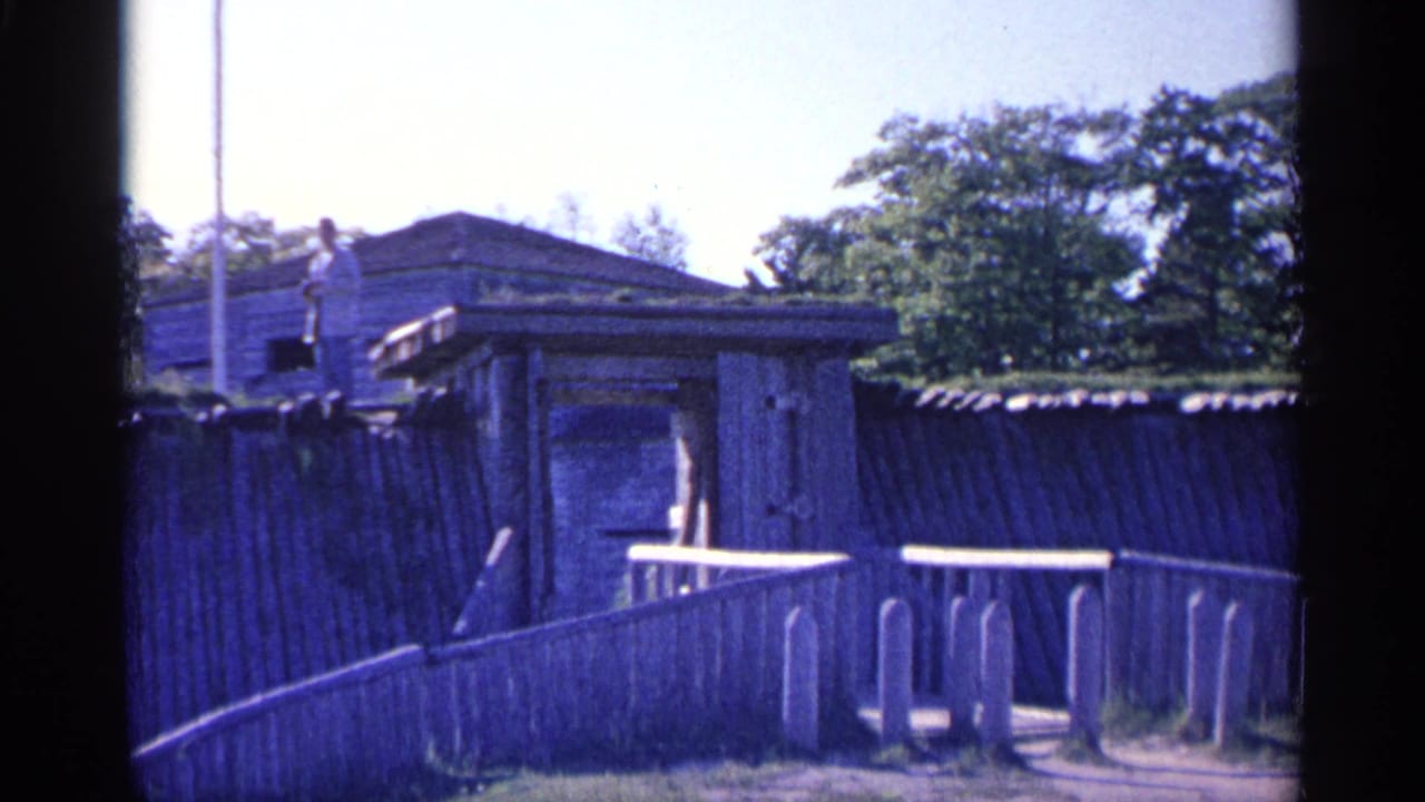 Wooden ramp, fence, and fort structure with a small person standing above.