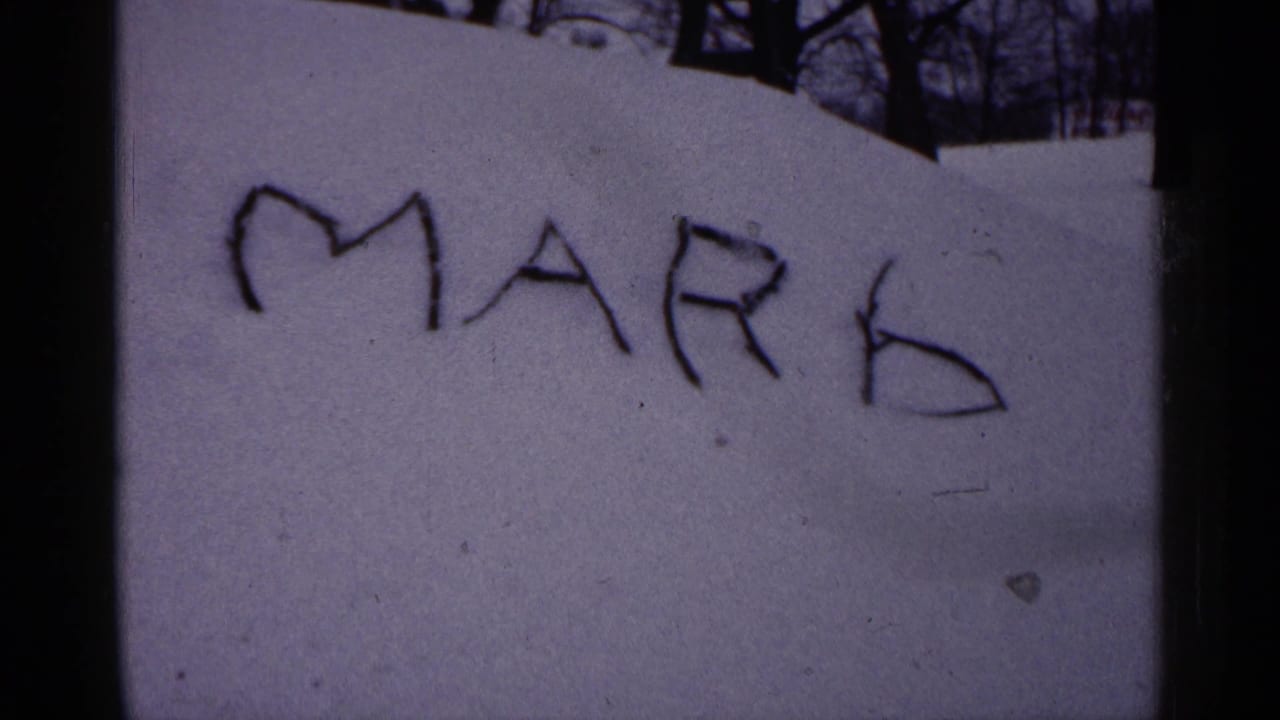 The word MARK written in snow on a sloped outdoor surface.