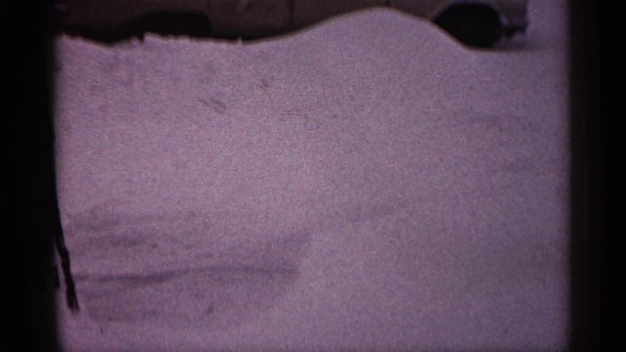 Classic car partly buried behind a high snow drift with only the upper body visible.
