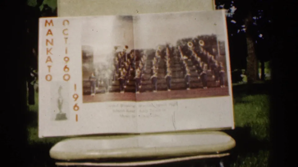 An open Mankato program in Minnesota shows a marching band photograph, vertical lettering, and printed 1960 and 1961 dates.
