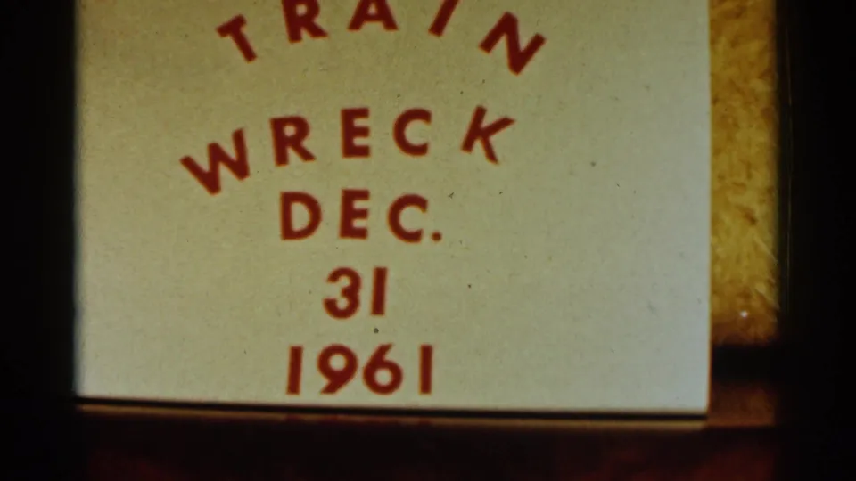 1961 8mm frame showing a handwritten or printed label reading Train Wreck Dec. 31 1961, photographed before the Bird Island winter scene.