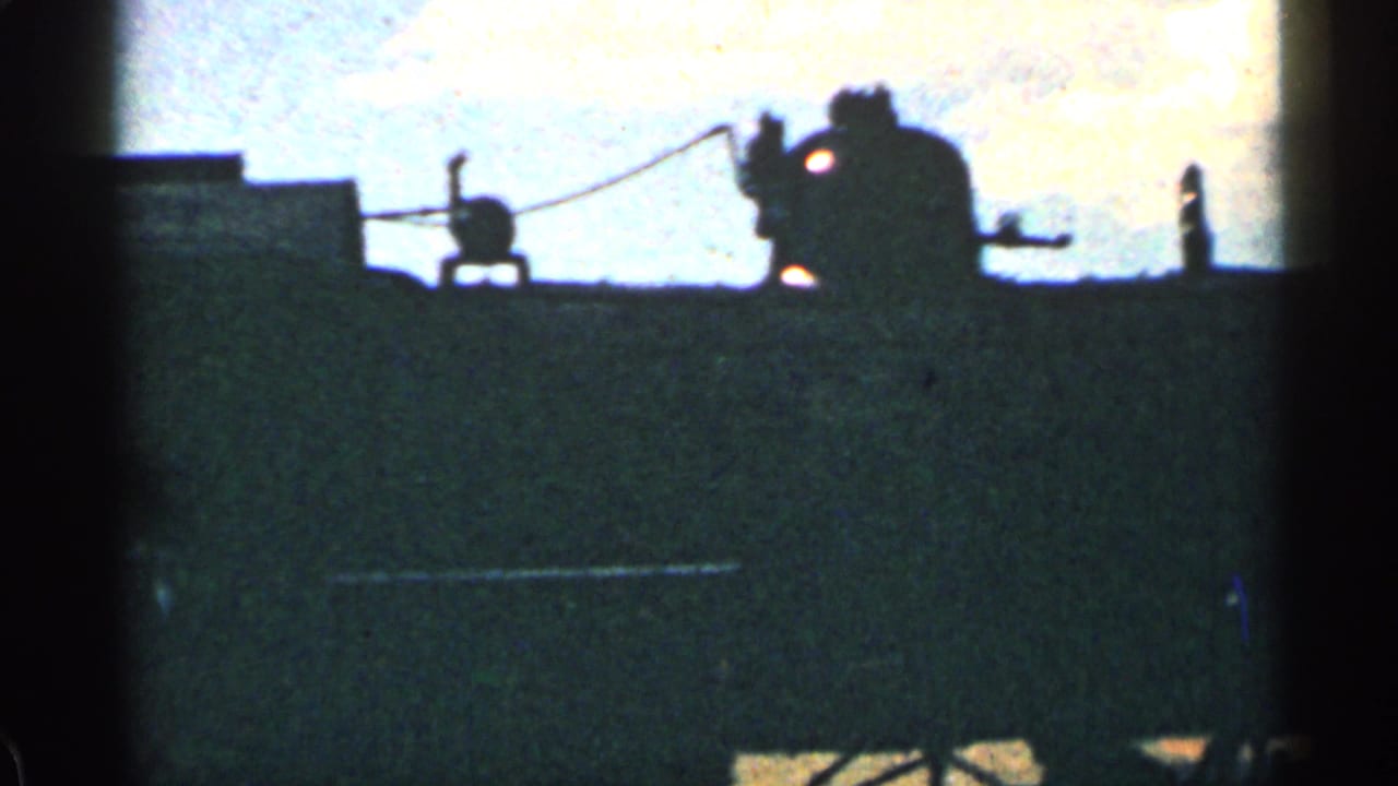 Silhouetted steam locomotive detail against a bright sky.
