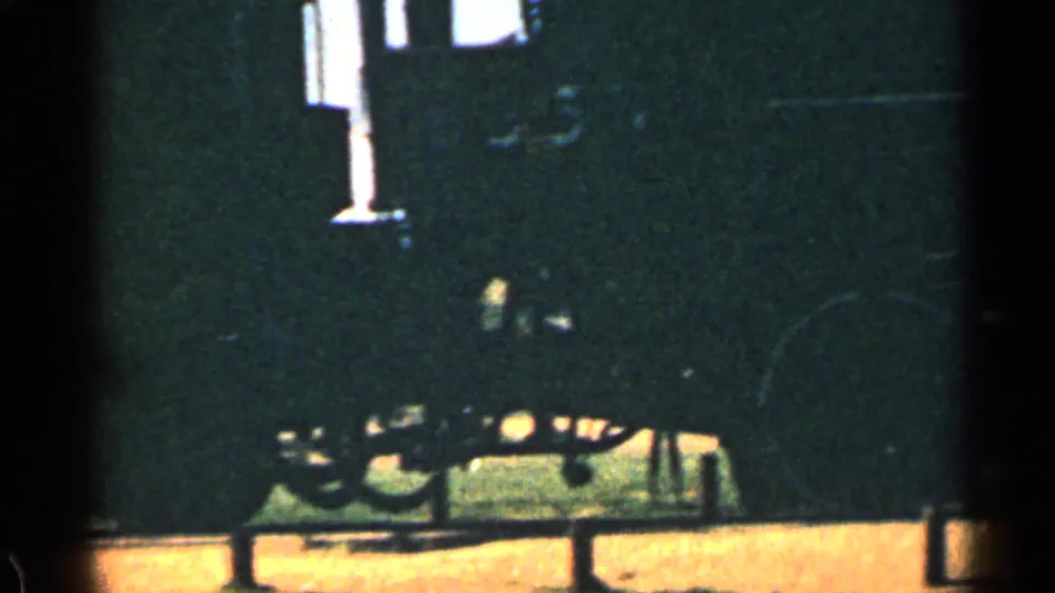 A dark side view of the locomotive and running gear, partly obscured by shadow and 8mm exposure contrast.