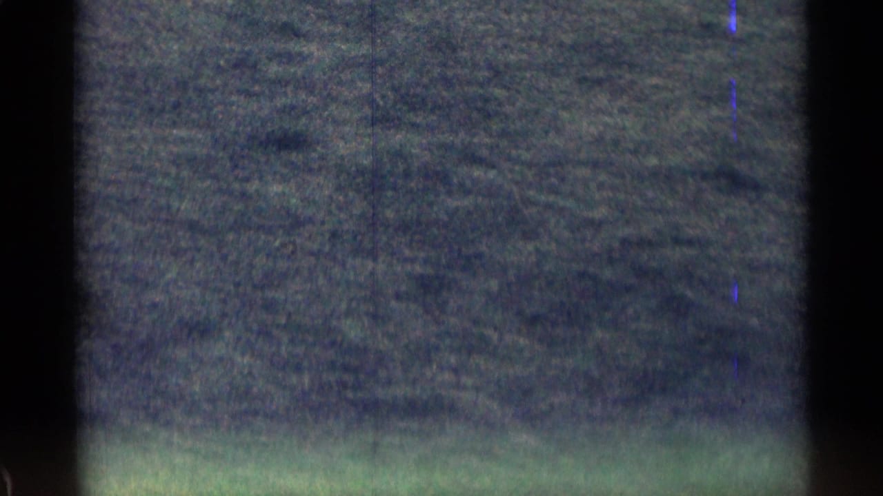 1963 8mm Colorado road footage showing a soft, underexposed view of open land through a moving camera frame.