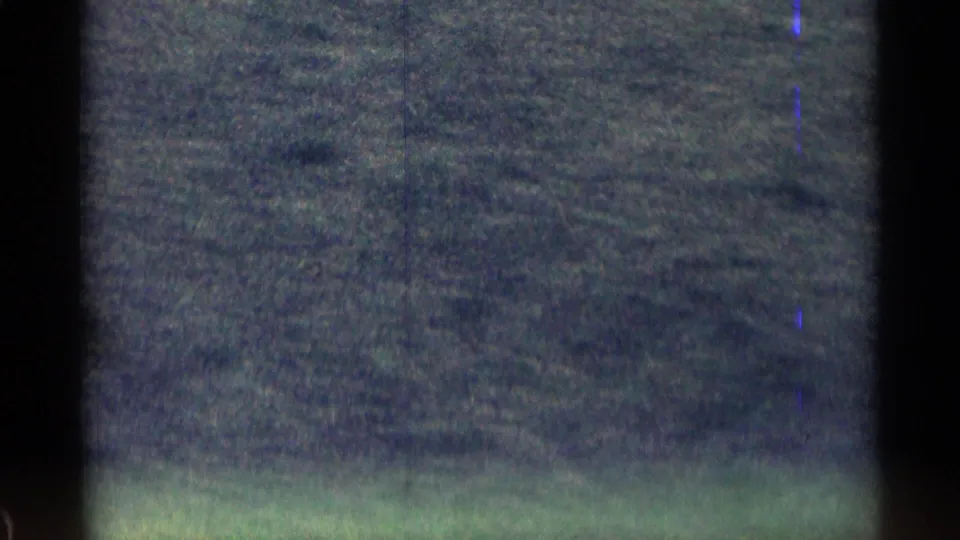 1963 8mm Colorado road footage showing a soft, underexposed view of open land through a moving camera frame.