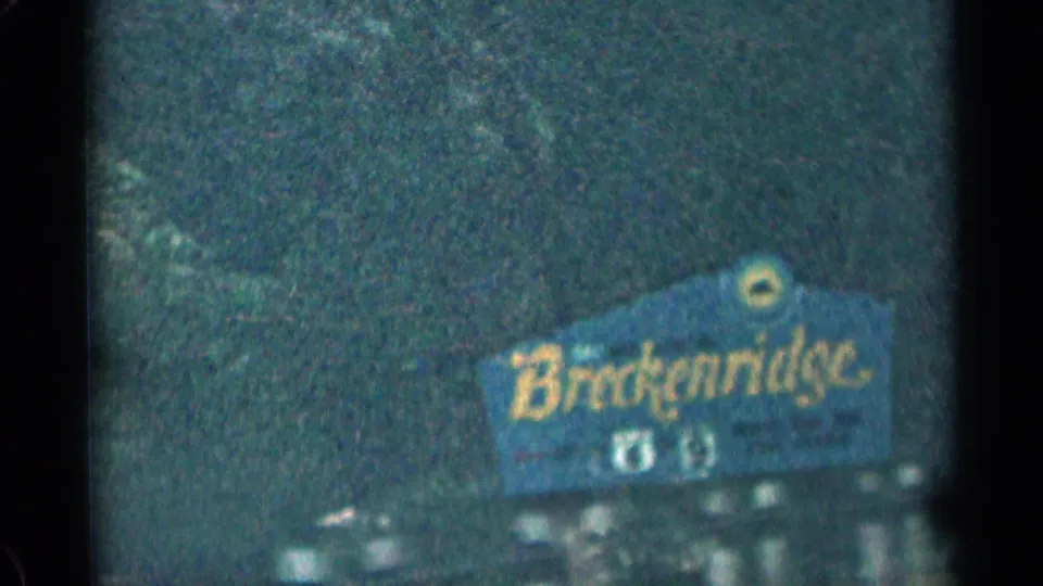 Blue Breckenridge roadside sign appears in a soft 1963 Colorado 8mm travel frame.