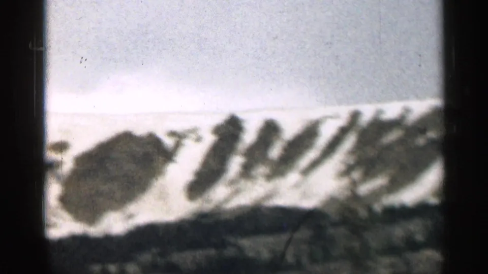 8mm Colorado mountain view with snow patches on a distant slope and soft exposure across the sky.