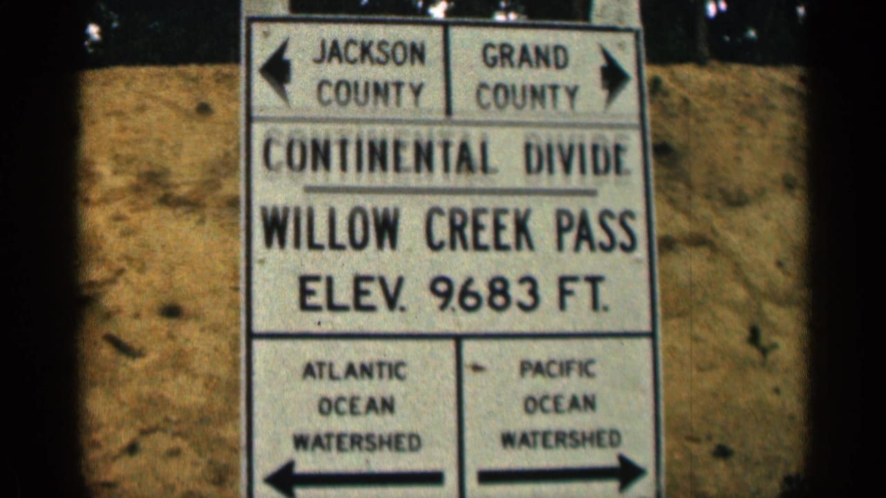 Close 1963 Colorado view of the Willow Creek Pass Continental Divide sign, including Atlantic and Pacific Ocean watershed labels.