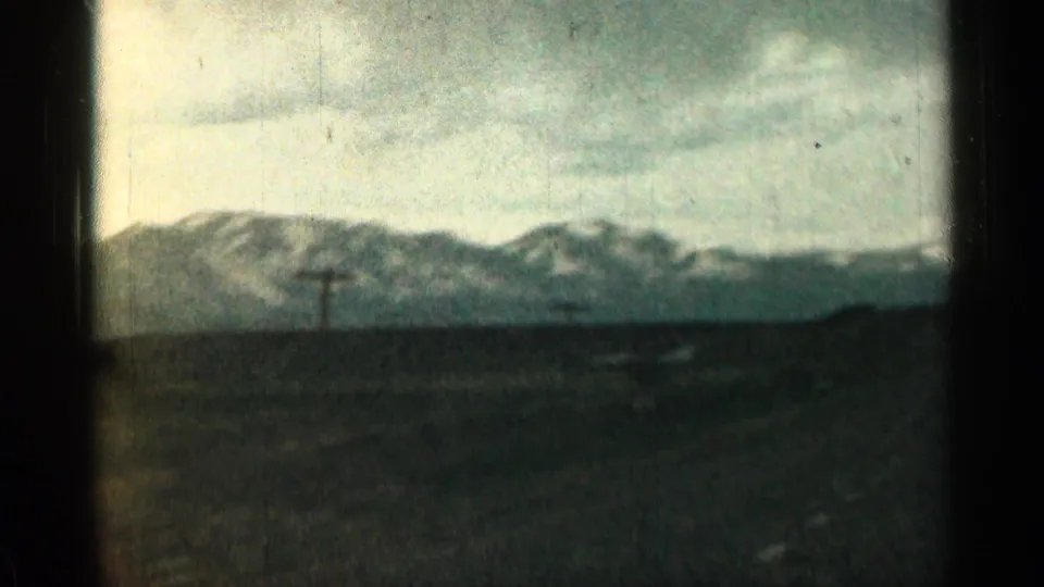 Colorado mountain landscape seen through a moving vehicle window, with utility poles crossing the view.
