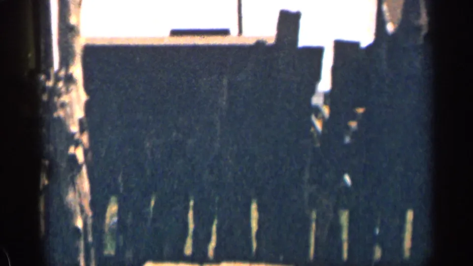 1963 Colorado frame showing a preserved wooden gallows with a noose hanging from the crossbeam, partly obscured by shadow and film edge.