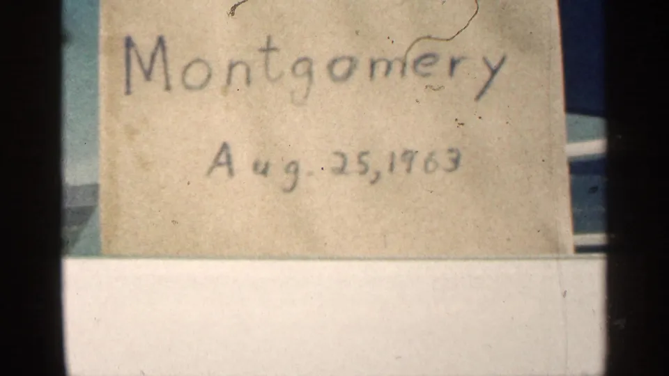 Aged handwritten Montgomery, Minnesota label dated Aug. 25, 1963, shown with scratches, dust, and dark 8mm frame borders.