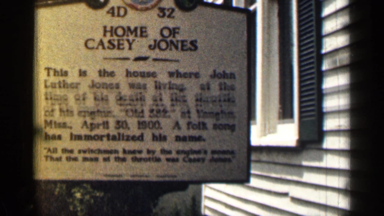 Home of Casey Jones marker mounted beside white siding and a shuttered window.
