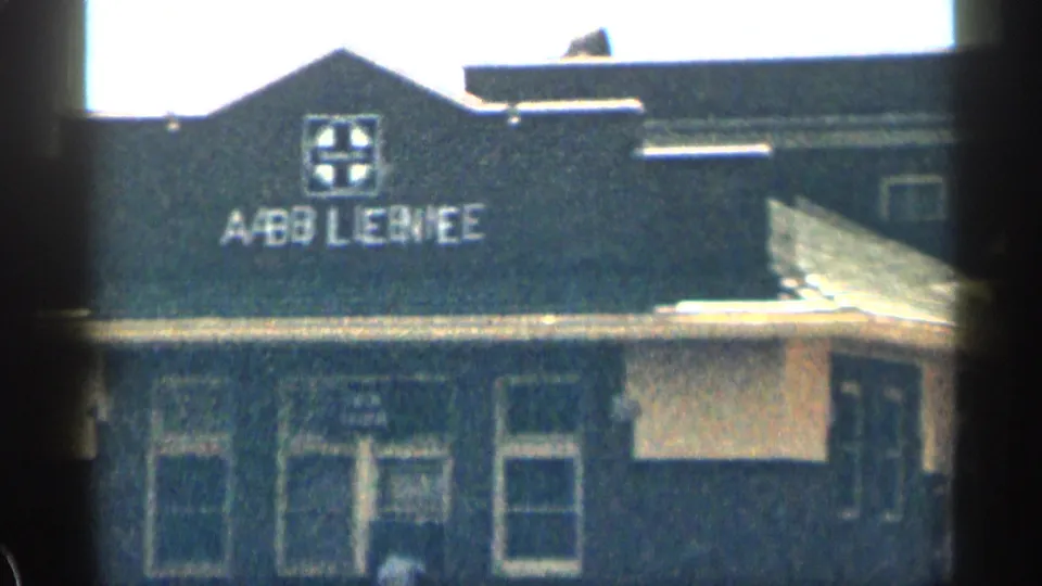 Soft 8mm view of a dark building facade in Texas with Abilene lettering, windows, and roofline visible.