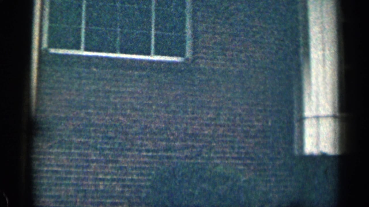 Close view of brick wall with tall white trim and partial windows near the top.