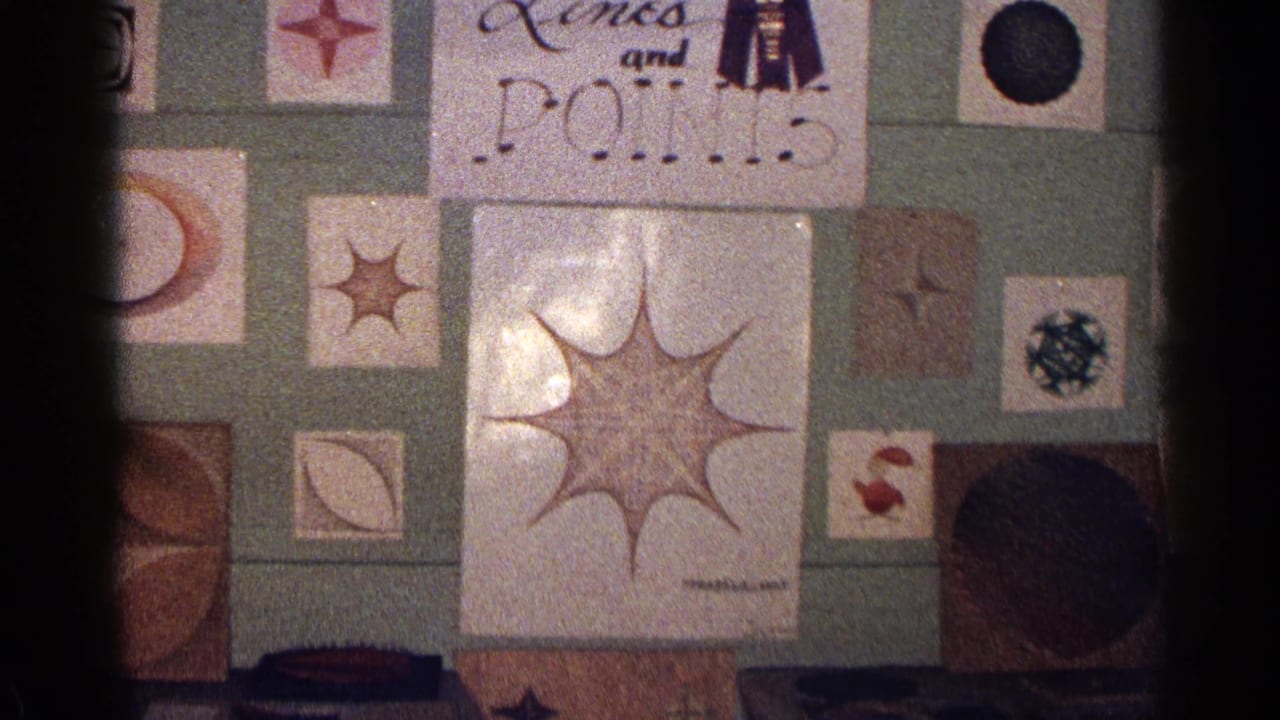 Wall-mounted abstract drawings with starbursts, circles, and a partially visible sign.