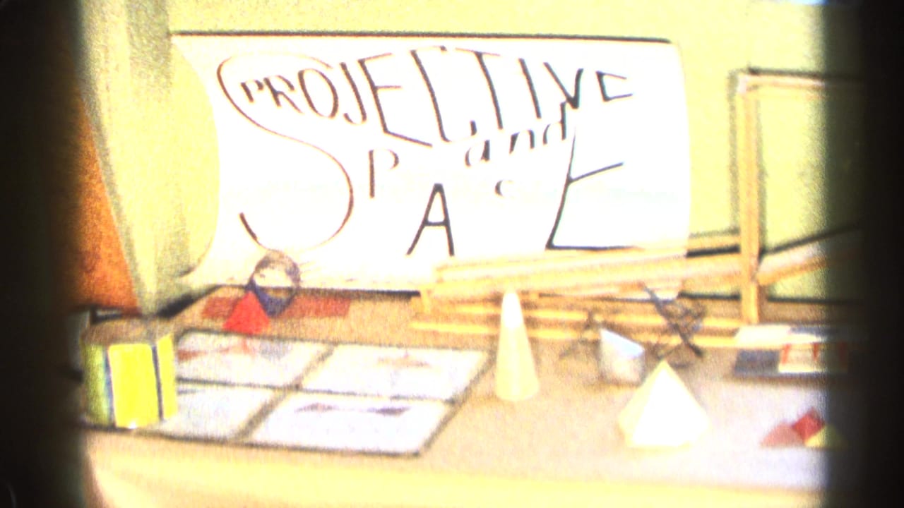 Handmade projective space display with paper forms on a tabletop.