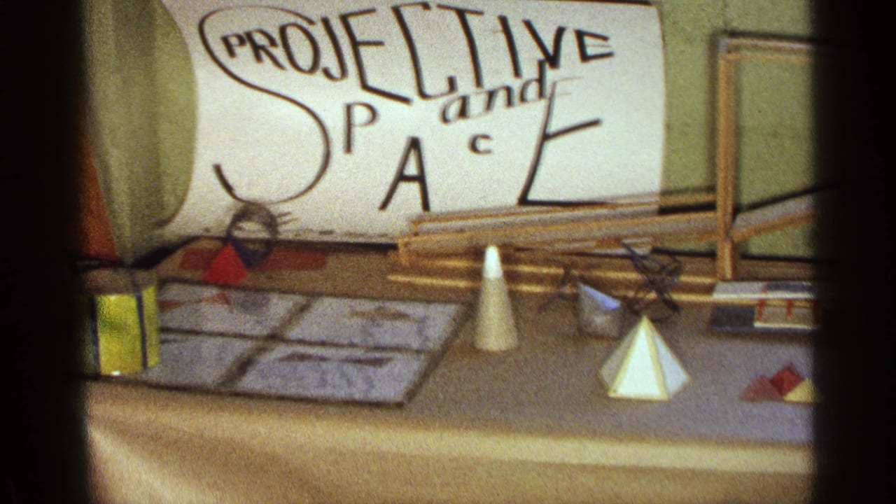 Science fair display table with sign, cones, pyramids, rods, and papers.
