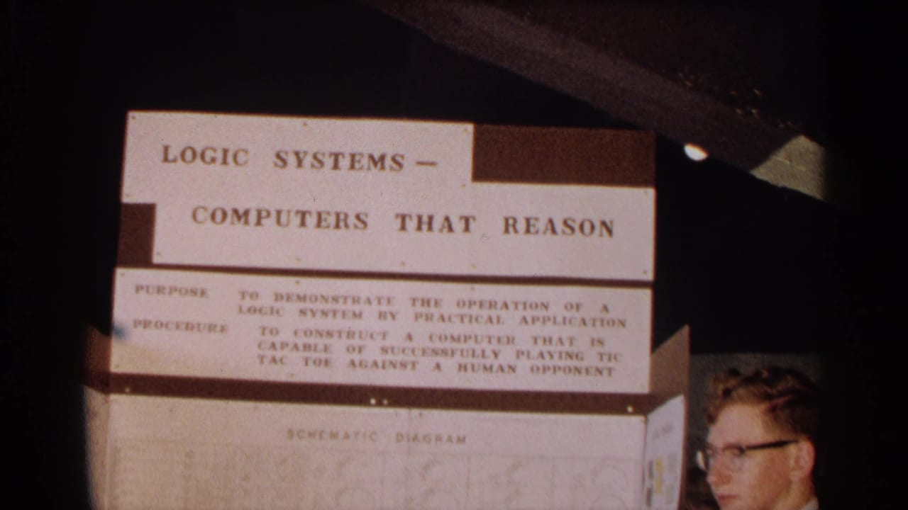 Student partly visible beside a Logic Systems Computers That Reason science fair display.