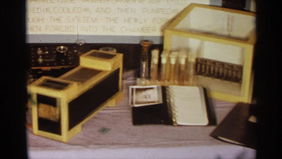1963 Texas high school science fair table with ozone project equipment, glass tubes, handwritten notes, and explanatory panels in the background.