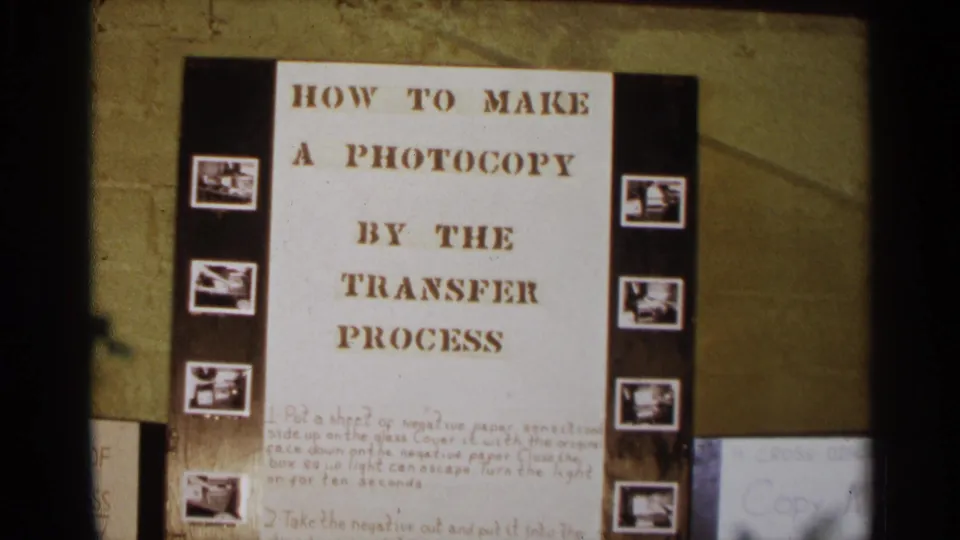1963 Texas 8mm frame showing a classroom-style placard explaining how to make a photocopy by the transfer process.
