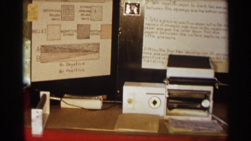 Final frame shows diagrams labeled with negative and positive layers beside notes and a small tabletop machine.