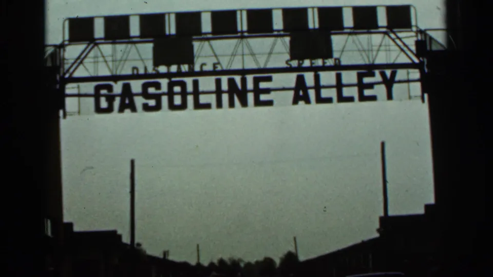 The Gasoline Alley sign is seen above a trackside structure at the Indianapolis race-track location referenced in the metadata.