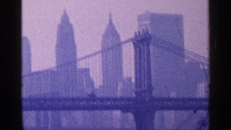 1964 New York City home-movie view of the Manhattan skyline and a suspension bridge across the river.