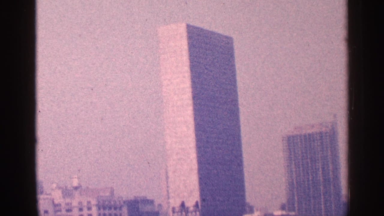 United Nations Secretariat and nearby Manhattan towers seen through dark 8mm film borders.