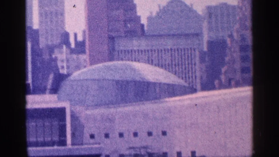 1964 New York City skyline view with a domed building in the foreground and office towers rising behind it.