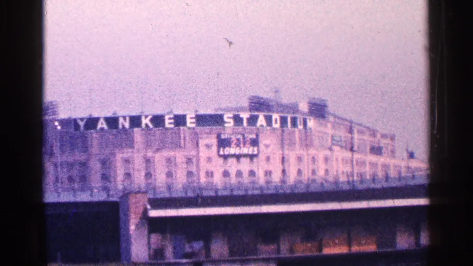 1964 New York City home-movie view of the Yankee Stadium exterior with the stadium name visible across the facade.
