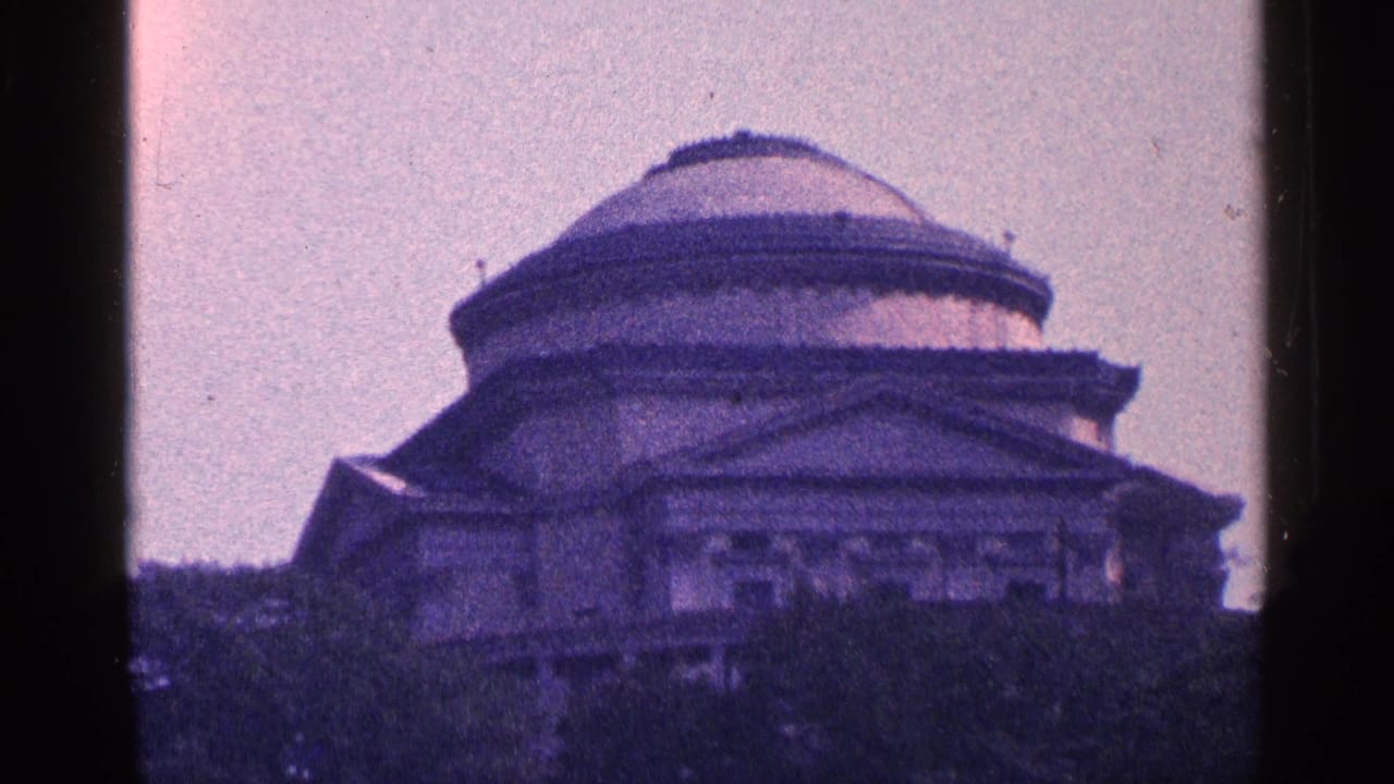 Large domed classical building seen through dark film-frame borders.