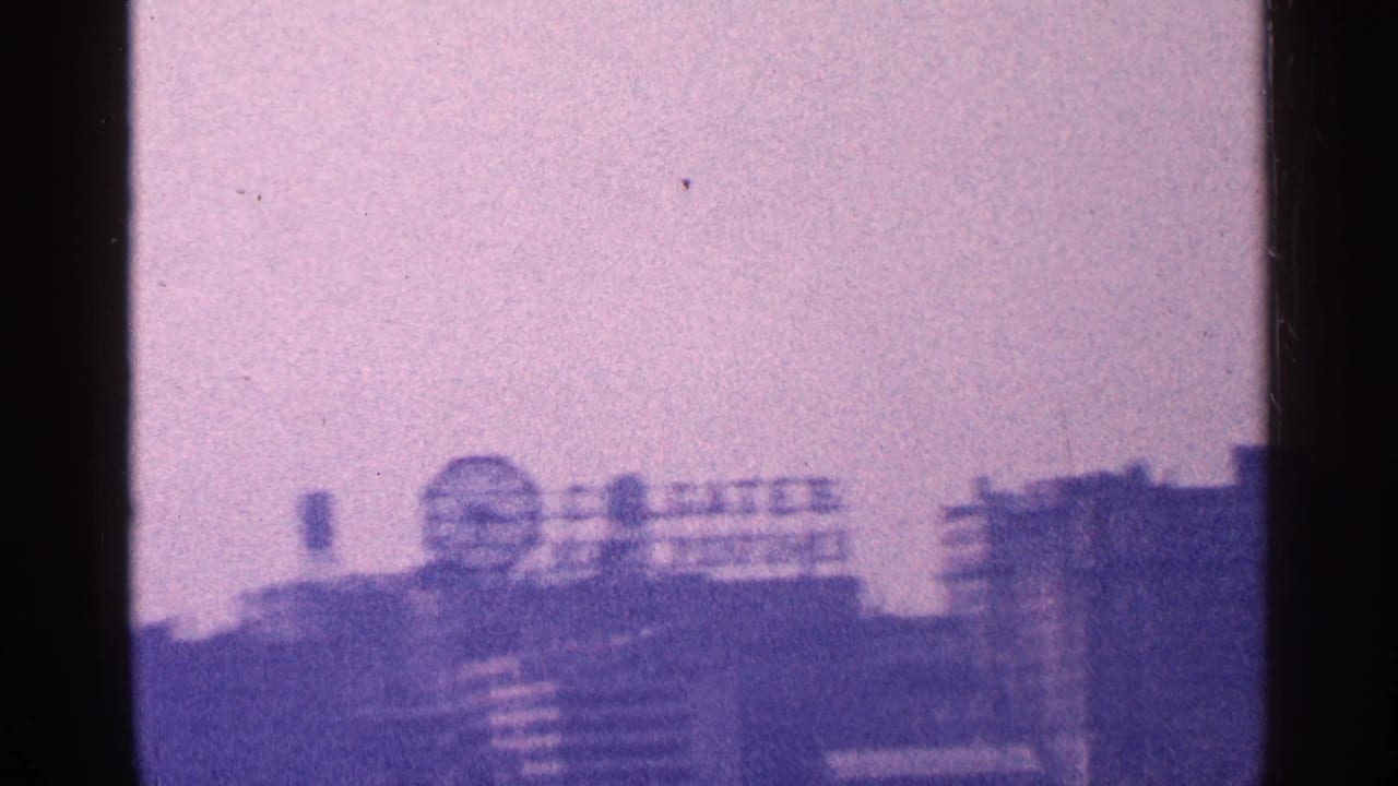 A second 1964 New York City waterfront angle shows the Colgate Clock and rooftop sign softened by grain and color shift.
