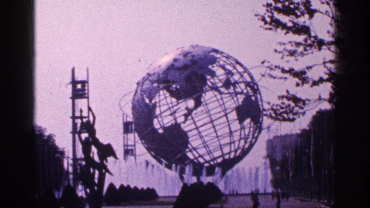 Unisphere seen across fountains with dark park edges and hazy sky.
