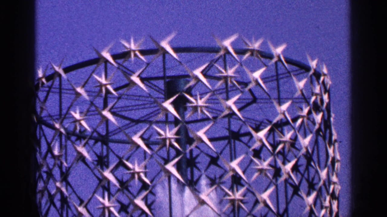 1964 New York City home-movie frame showing a decorative church interior detail with star-like lattice shapes and soft blue-purple color.
