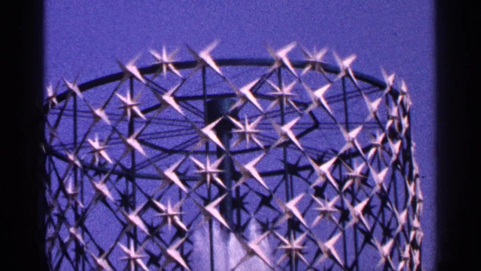 1964 New York City home-movie frame showing a decorative church interior detail with star-like lattice shapes and soft blue-purple color.