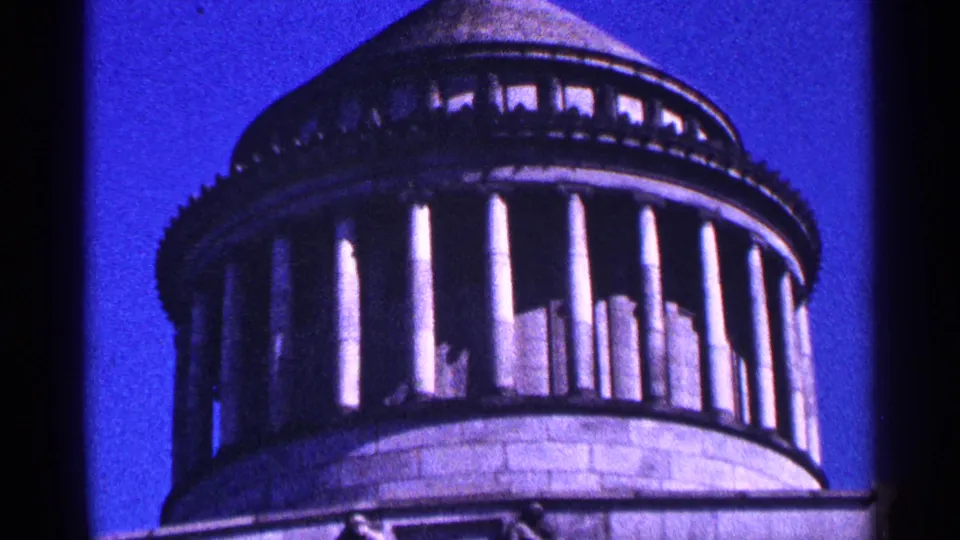 Close 1964 New York City home-movie view of the domed building's columns and stonework against a saturated blue sky.