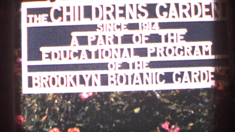 1964 New York City 8mm frame showing the Children's Garden sign, part of the Brooklyn Botanic Garden educational program.