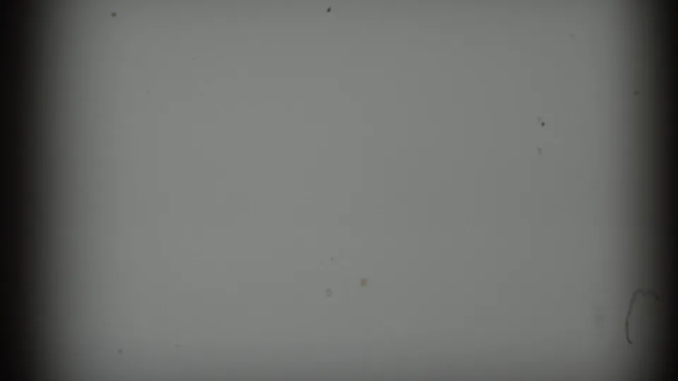 Mostly blank 1964 8mm frame with a central dark band, light falloff, dust marks, and visible scan edges.
