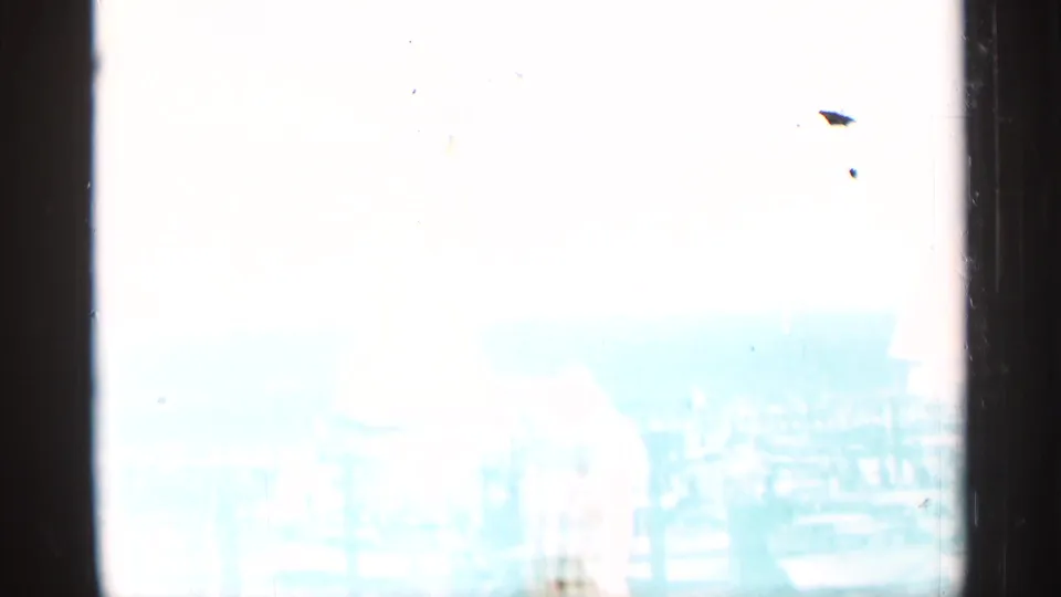 1964 8mm home-movie frame showing a bright, overexposed Niagara Falls view through dark film borders.