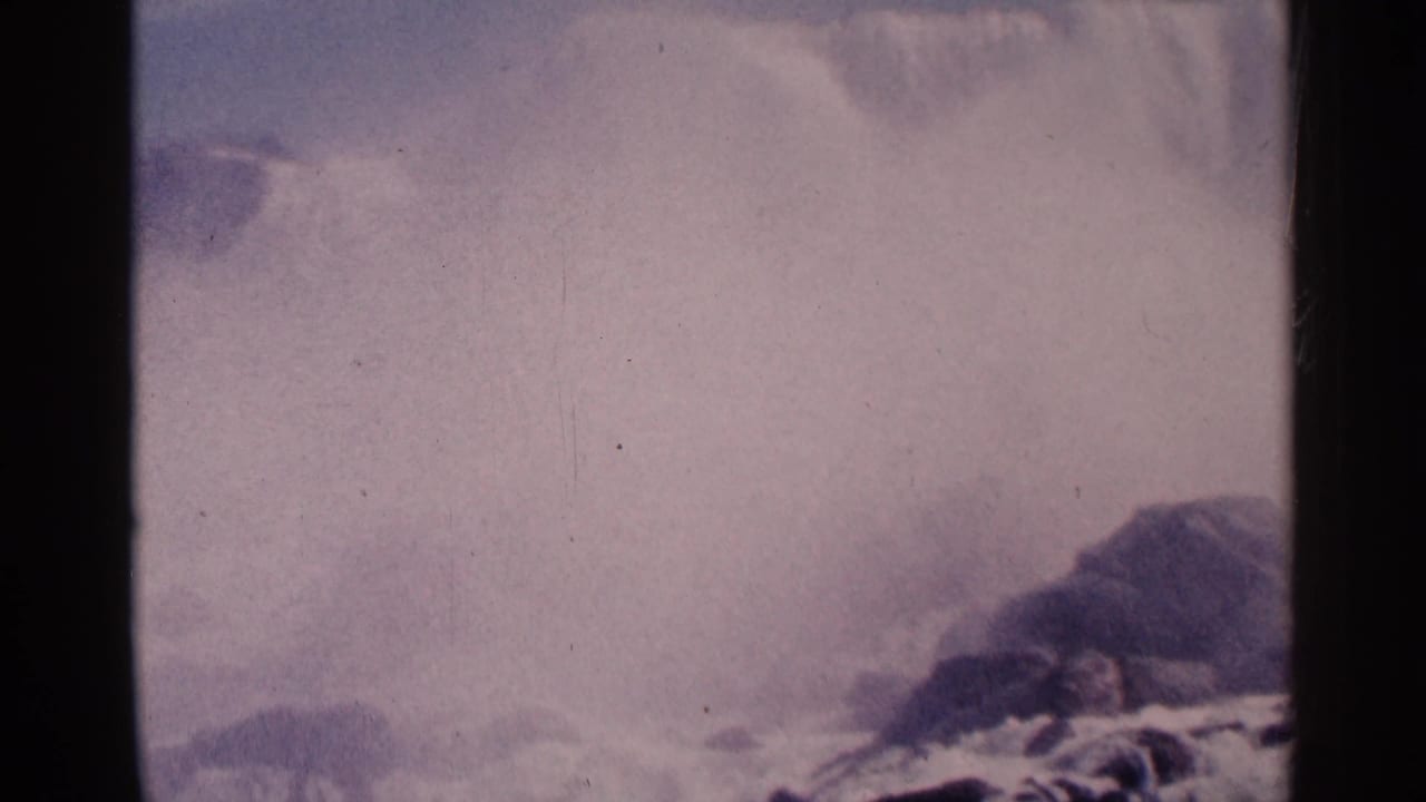 Waterfall mist and rocks seen through a faded 8mm frame.