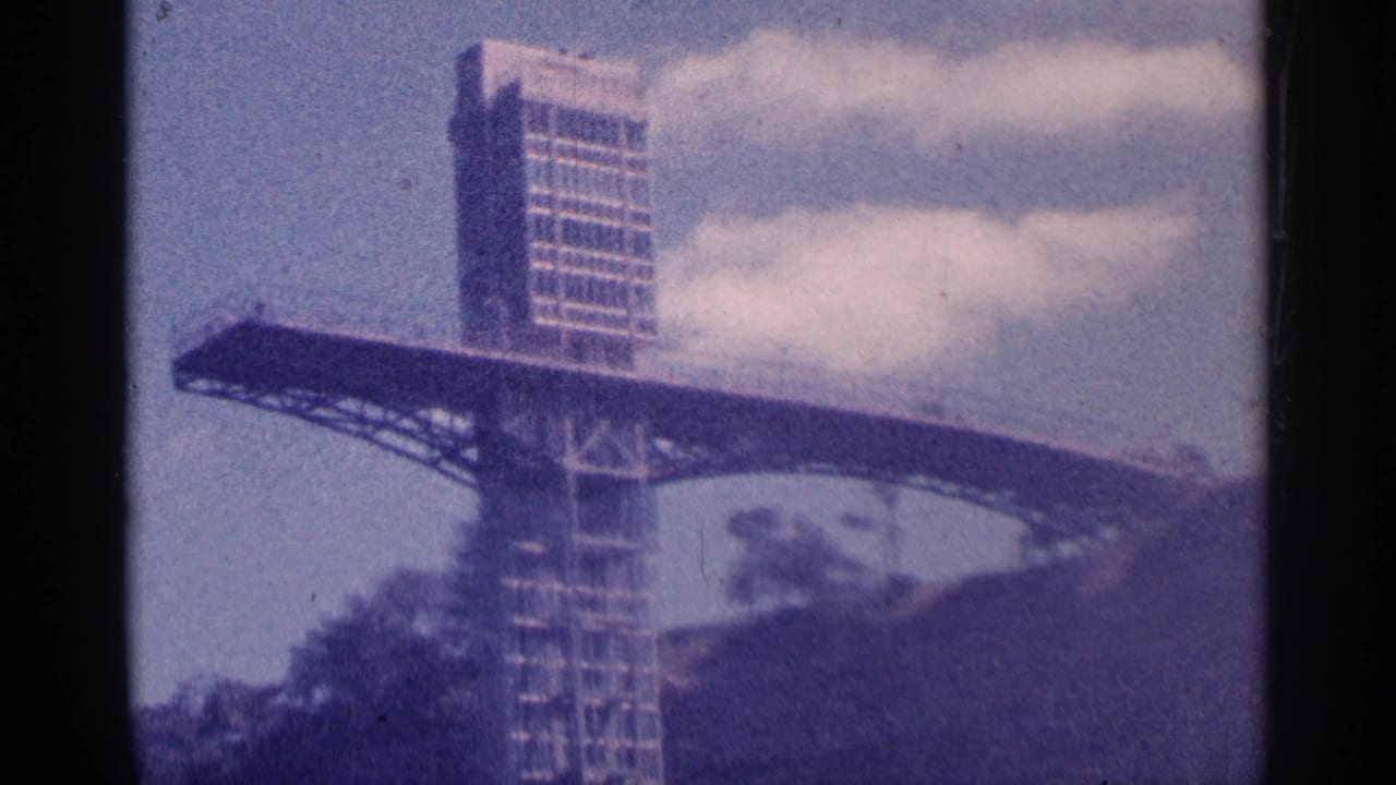 Observation tower and deck partly framed by dark film borders.