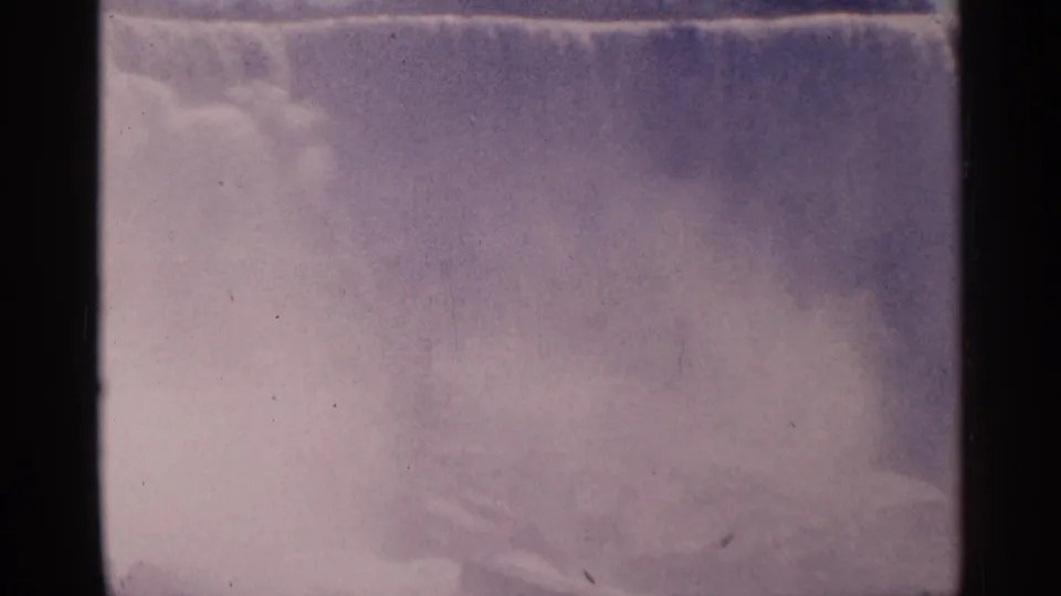 Final 1964 8mm frame of Niagara Falls, Canada, with the falls partly veiled by mist and visible archival film wear.
