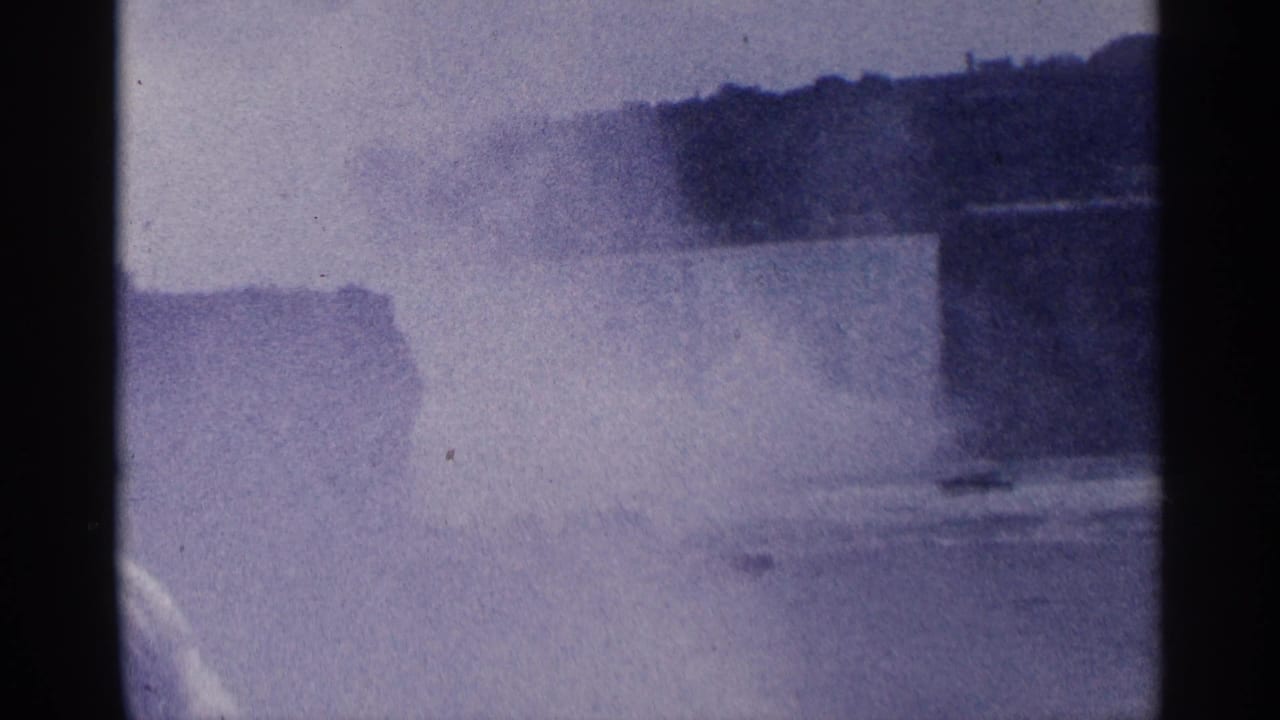 Wide view of Niagara Falls mist and river with dark film borders.