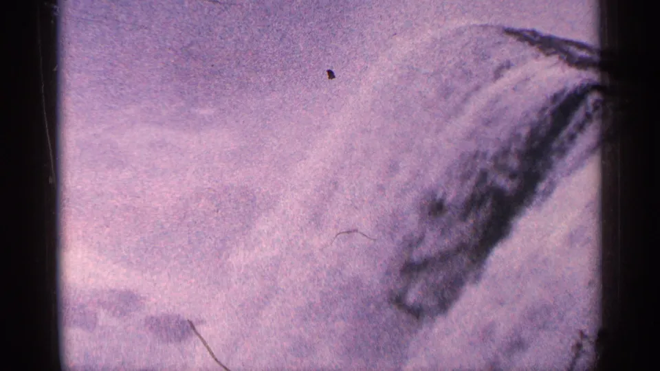 1964 Niagara Falls home-movie frame showing foamy rushing water with soft focus and aged color shift.