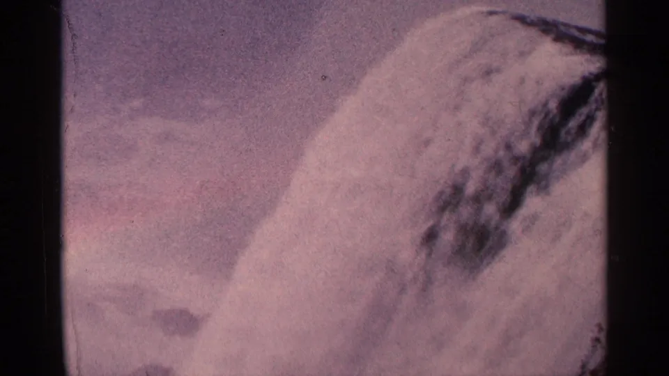 Aged 8mm frame of Niagara Falls, Canada, showing water rolling over the ledge into mist.