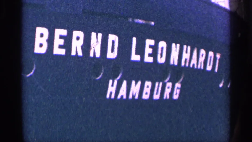 1964 8mm title card with white BERND LEONHARDT HAMBURG lettering on a dark blue background.