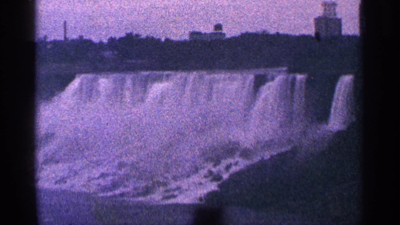 Wide view of Niagara Falls with mist and dark vertical film borders.