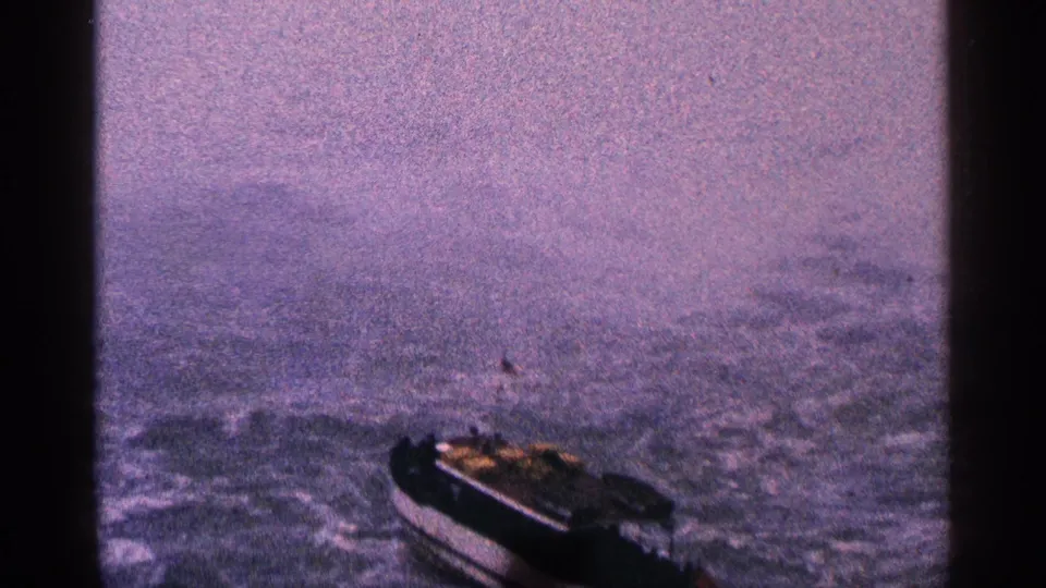 1964 Niagara Falls, Canada home-movie frame showing a small motorboat on rough water with soft focus and purple color shift.